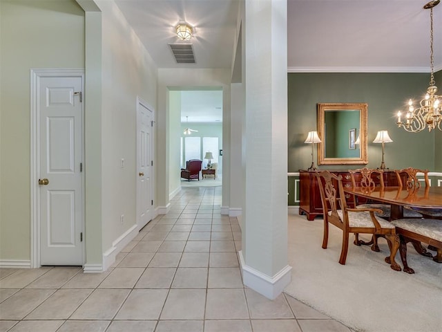8413 NW 64th Ter, Oklahoma City, OK 73132 - hallway featuring light tile patterned flooring, a chandelier, baseboards, and ornamental molding
