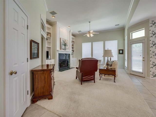8413 NW 64th Ter, Oklahoma City, OK 73132 - living area featuring crown molding, light tile patterned floors, a high end fireplace, a ceiling fan, and baseboards
