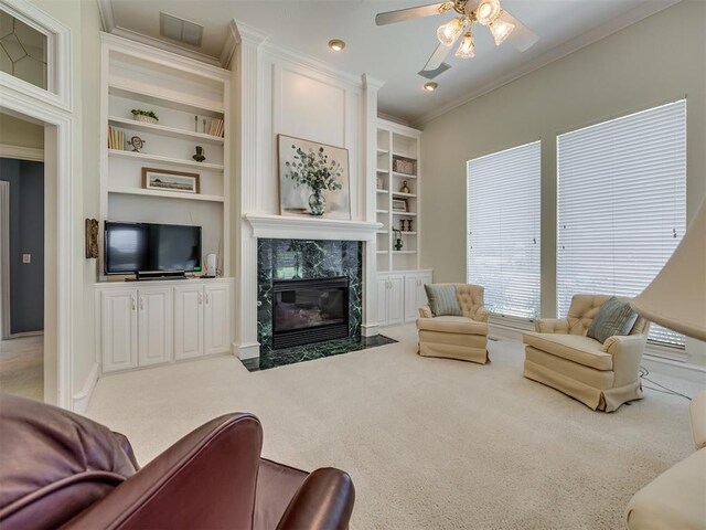 8413 NW 64th Ter, Oklahoma City, OK 73132 - living room featuring carpet flooring, crown molding, a fireplace, a ceiling fan, and built in features