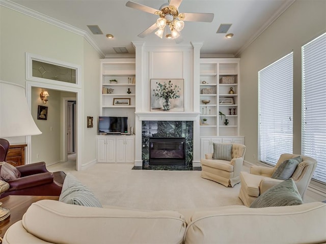 8413 NW 64th Ter, Oklahoma City, OK 73132 - living area featuring ornamental molding, a premium fireplace, ceiling fan, baseboards, and carpet