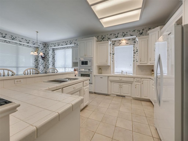 8413 NW 64th Ter, Oklahoma City, OK 73132 - kitchen with white appliances, tile counters, wallpapered walls, light tile patterned floors, and white cabinetry