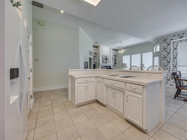 8413 NW 64th Ter, Oklahoma City, OK 73132 - kitchen featuring tile countertops, white appliances, a ceiling fan, white cabinets, and light tile patterned floors