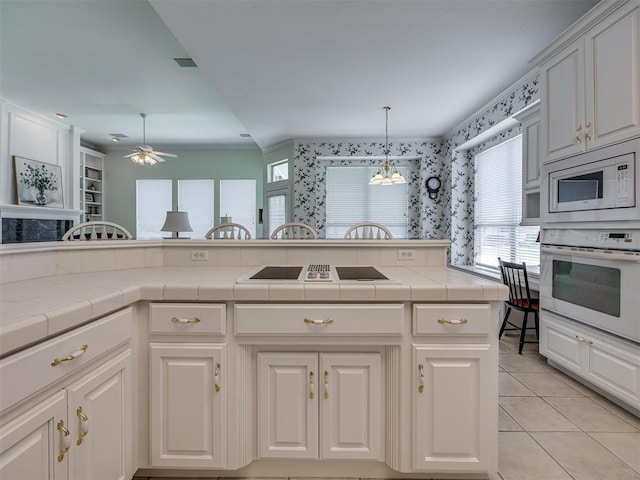 8413 NW 64th Ter, Oklahoma City, OK 73132 - kitchen featuring white appliances, light tile patterned floors, tile counters, and ceiling fan