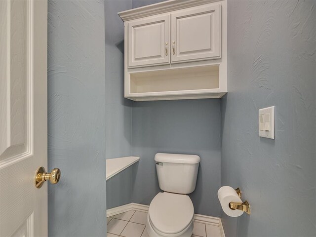 8413 NW 64th Ter, Oklahoma City, OK 73132 - bathroom featuring toilet, tile patterned floors, and baseboards