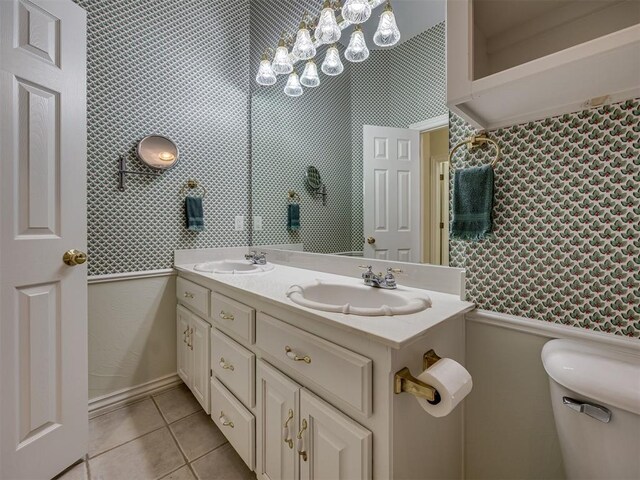 8413 NW 64th Ter, Oklahoma City, OK 73132 - full bathroom featuring tile patterned floors, double vanity, and toilet