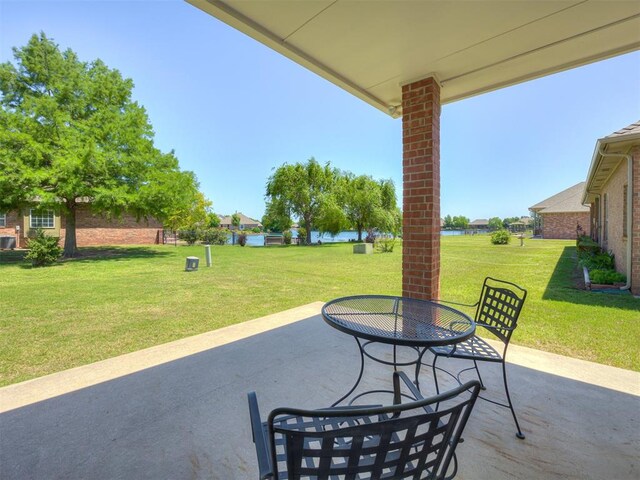 8413 NW 64th Ter, Oklahoma City, OK 73132 - view of patio / terrace featuring outdoor dining space and a water view
