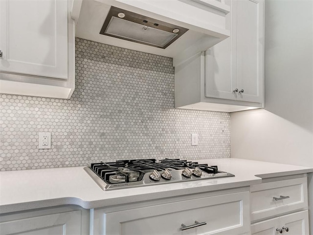 9212 NW 89th St, Yukon, OK 73099 - kitchen featuring stainless steel gas cooktop, light countertops, range hood, tasteful backsplash, and white cabinets