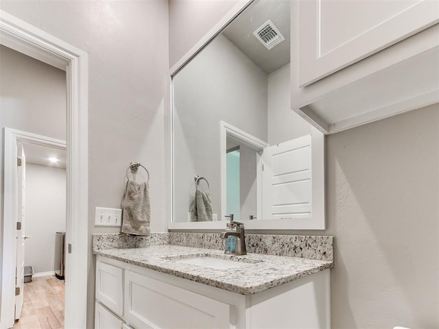 9212 NW 89th St, Yukon, OK 73099 - bathroom featuring vanity and wood finished floors