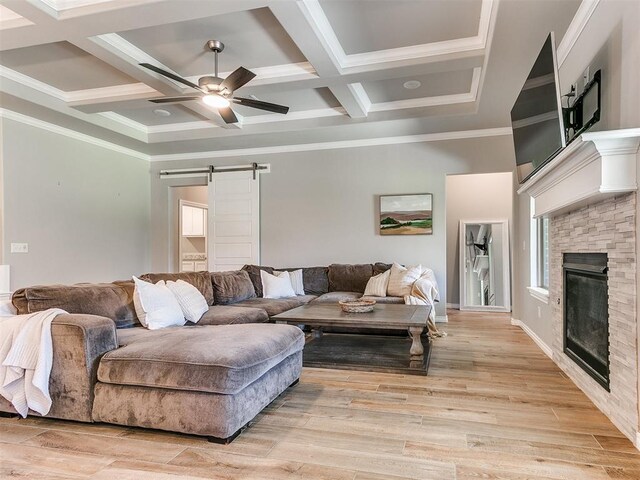 9212 NW 89th St, Yukon, OK 73099 - living area featuring a barn door, coffered ceiling, a ceiling fan, ornamental molding, and beam ceiling