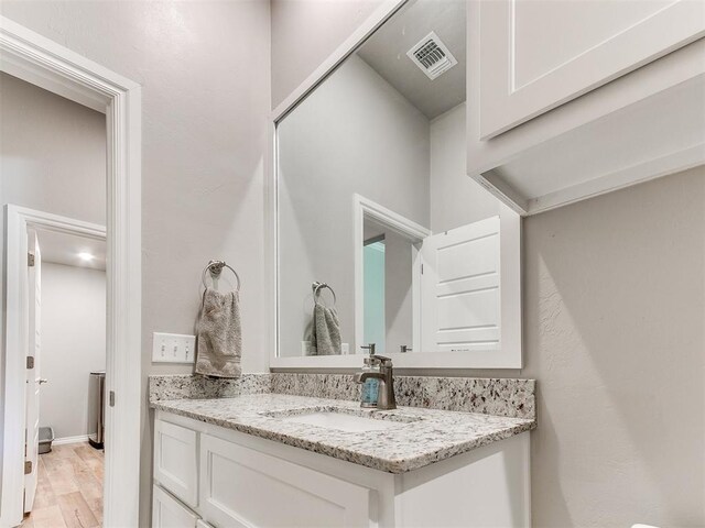 9212 NW 89th St, Yukon, OK 73099 - bathroom featuring vanity and wood finished floors