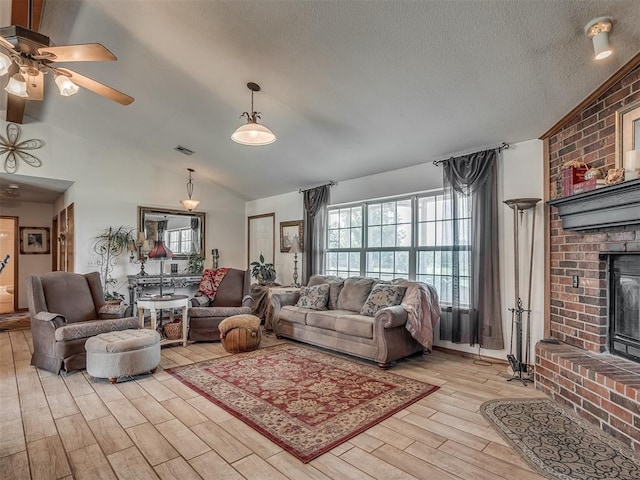 870756 S 3460th Rd, Chandler, OK 74834 - living room featuring vaulted ceiling, healthy amount of natural light, light wood-type flooring, a fireplace, and a ceiling fan