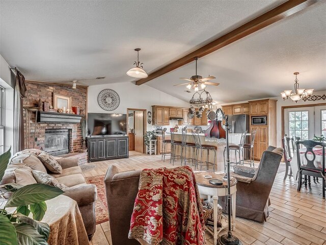 870756 S 3460th Rd, Chandler, OK 74834 - living area featuring light wood-style floors, a brick fireplace, a chandelier, and a ceiling fan