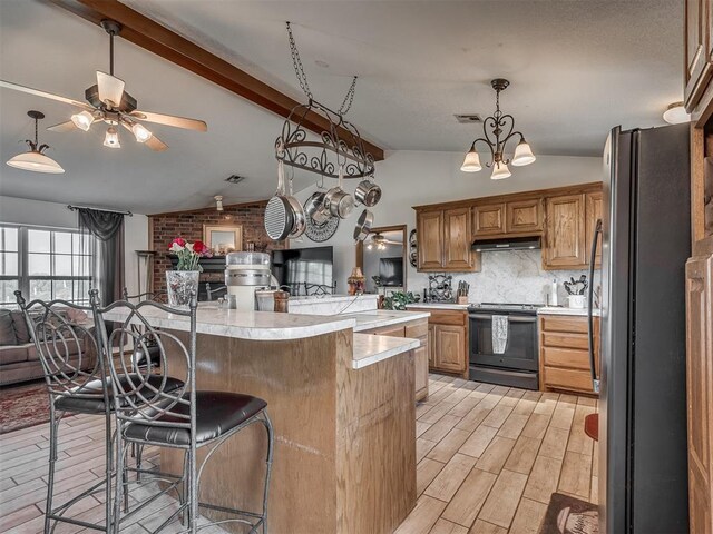 870756 S 3460th Rd, Chandler, OK 74834 - kitchen with black range with electric cooktop, freestanding refrigerator, open floor plan, light countertops, and a breakfast bar