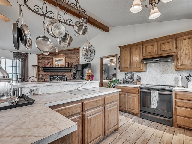 870756 S 3460th Rd, Chandler, OK 74834 - kitchen featuring range with electric cooktop, under cabinet range hood, light countertops, decorative backsplash, and a fireplace