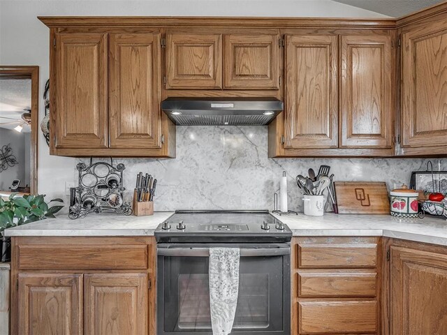 870756 S 3460th Rd, Chandler, OK 74834 - kitchen with range with electric stovetop, range hood, light countertops, and decorative backsplash