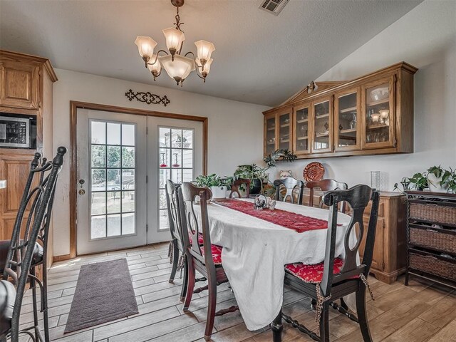 870756 S 3460th Rd, Chandler, OK 74834 - dining area featuring a chandelier, light wood finished floors, and lofted ceiling