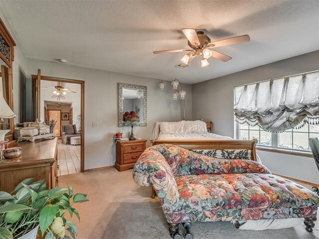 870756 S 3460th Rd, Chandler, OK 74834 - bedroom featuring a textured ceiling, light carpet, ceiling fan, and baseboards