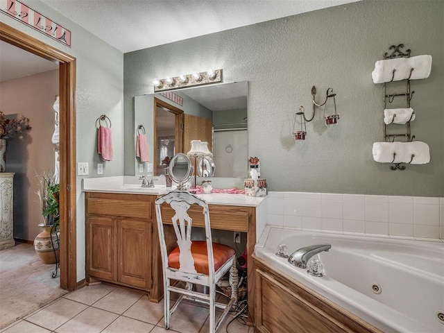 870756 S 3460th Rd, Chandler, OK 74834 - bathroom featuring vanity, a jetted tub, tile patterned flooring, and a textured wall