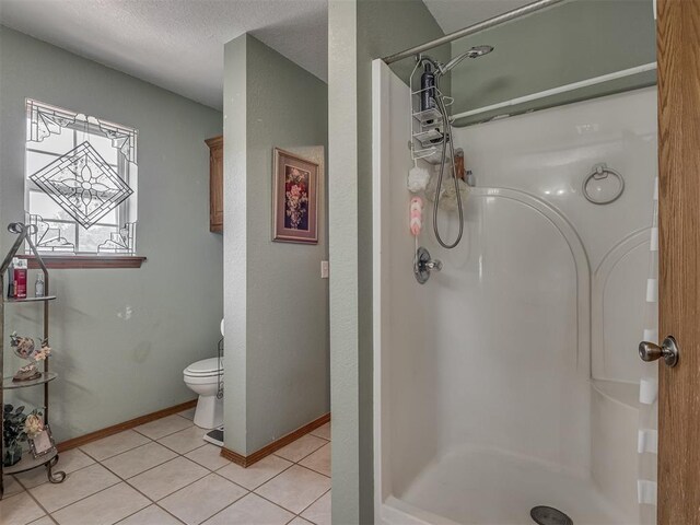 870756 S 3460th Rd, Chandler, OK 74834 - full bath with a stall shower, toilet, tile patterned flooring, baseboards, and a textured ceiling