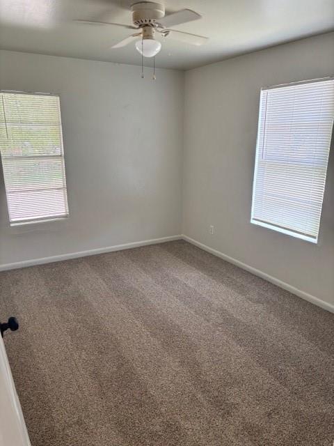 3229 NE 14th Pl, Oklahoma City, OK 73117 - unfurnished room with carpet, baseboards, and a ceiling fan