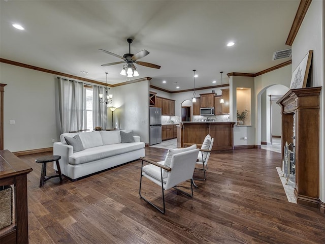 18854 Marbella Ln, Harrah, OK 73045 - living room featuring arched walkways, ceiling fan, ornamental molding, dark wood-type flooring, and baseboards