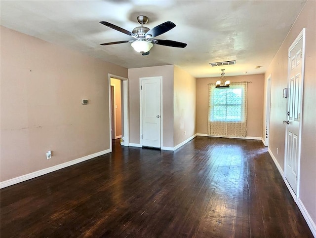 264 E Coe Dr, Midwest City, OK 73110 - unfurnished room featuring dark wood-style floors, a chandelier, ceiling fan, and baseboards