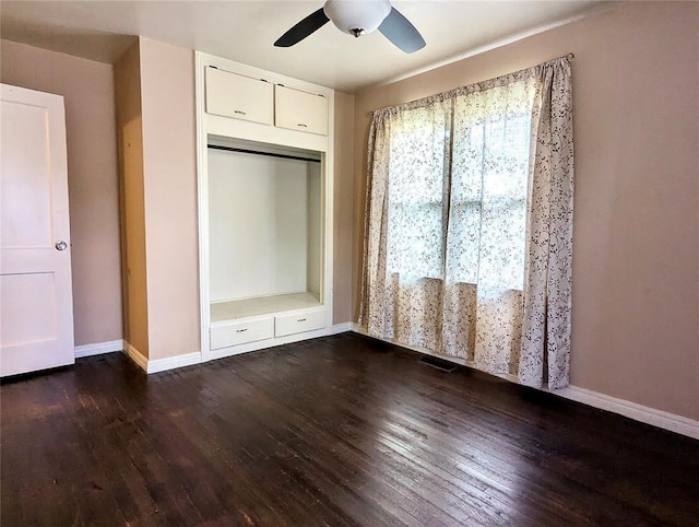 264 E Coe Dr, Midwest City, OK 73110 - unfurnished bedroom with wood finished floors, baseboards, and a ceiling fan