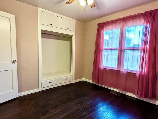 264 E Coe Dr, Midwest City, OK 73110 - unfurnished bedroom featuring wood finished floors, baseboards, and a ceiling fan
