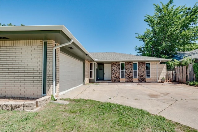 1309 NW 106th St, Oklahoma City, OK 73114 - view of front of home featuring brick siding, an attached garage, and concrete driveway
