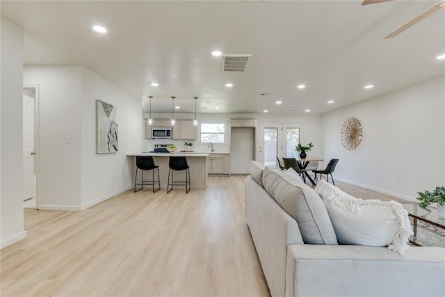 1309 NW 106th St, Oklahoma City, OK 73114 - living room featuring light wood-type flooring, recessed lighting, baseboards, and ceiling fan