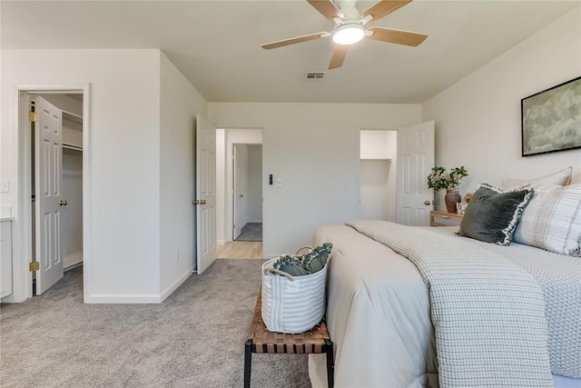 1309 NW 106th St, Oklahoma City, OK 73114 - bedroom with light colored carpet, a spacious closet, baseboards, and ceiling fan