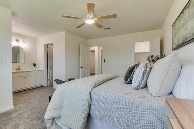 1309 NW 106th St, Oklahoma City, OK 73114 - bedroom featuring light colored carpet, ensuite bathroom, ceiling fan, and a sink