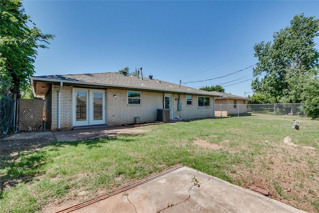 1309 NW 106th St, Oklahoma City, OK 73114 - back of house featuring brick siding, a patio, and central AC unit