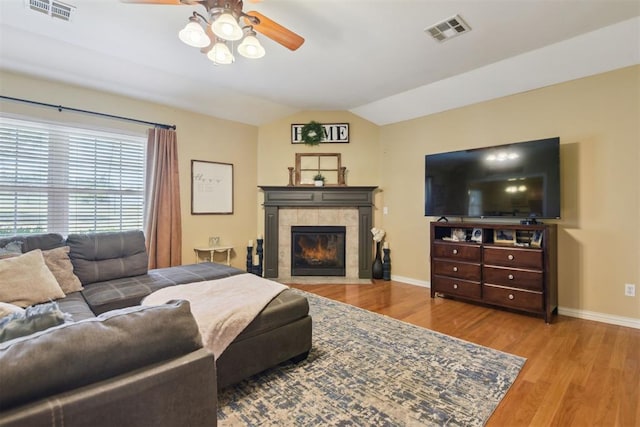 605 S Timber Ridge Dr, Cushing, OK 74023 - living area with a ceiling fan, baseboards, wood finished floors, lofted ceiling, and a tiled fireplace