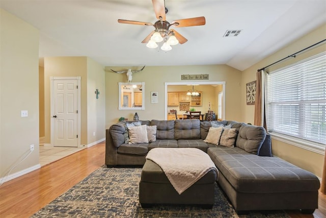 605 S Timber Ridge Dr, Cushing, OK 74023 - living room with light wood-style flooring, a ceiling fan, baseboards, vaulted ceiling, and a chandelier