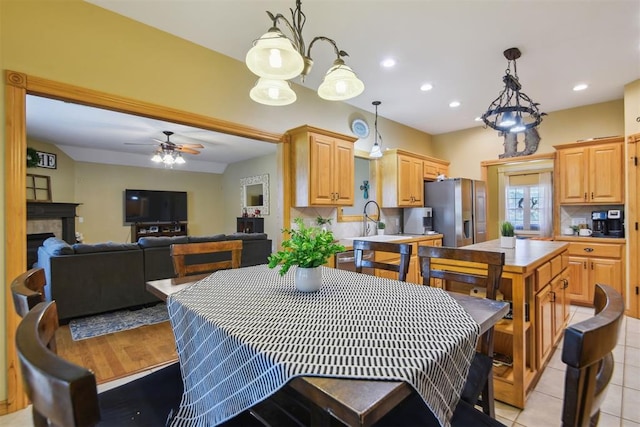 605 S Timber Ridge Dr, Cushing, OK 74023 - dining area featuring ceiling fan, recessed lighting, a fireplace, and light tile patterned floors