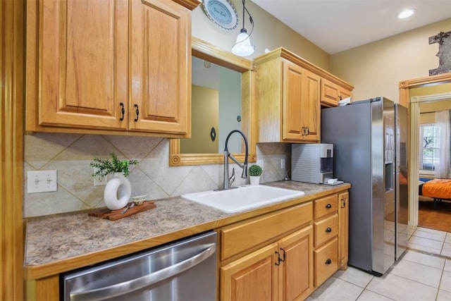605 S Timber Ridge Dr, Cushing, OK 74023 - kitchen with a sink, appliances with stainless steel finishes, tasteful backsplash, light tile patterned flooring, and light countertops