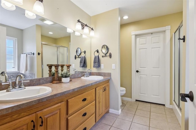 605 S Timber Ridge Dr, Cushing, OK 74023 - full bathroom featuring a shower stall, double vanity, tile patterned floors, toilet, and baseboards