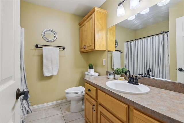 605 S Timber Ridge Dr, Cushing, OK 74023 - bathroom with vanity, toilet, tile patterned floors, baseboards, and a shower with shower curtain