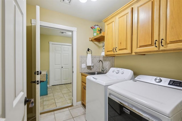 605 S Timber Ridge Dr, Cushing, OK 74023 - laundry area with cabinet space, washer and dryer, and light tile patterned flooring