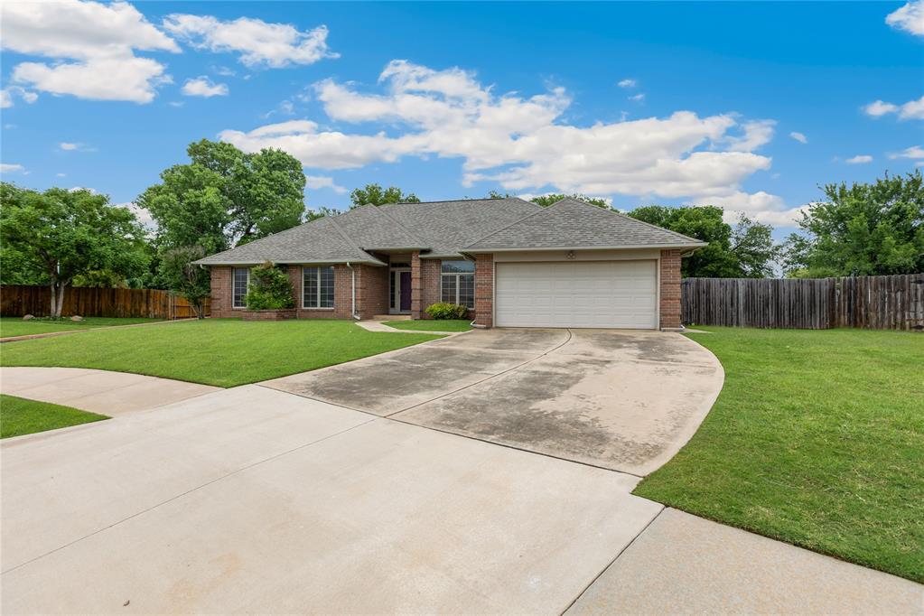 11800 Talver Ln, Oklahoma City, OK 73170 - single story home featuring concrete driveway, brick siding, an attached garage, and roof with shingles
