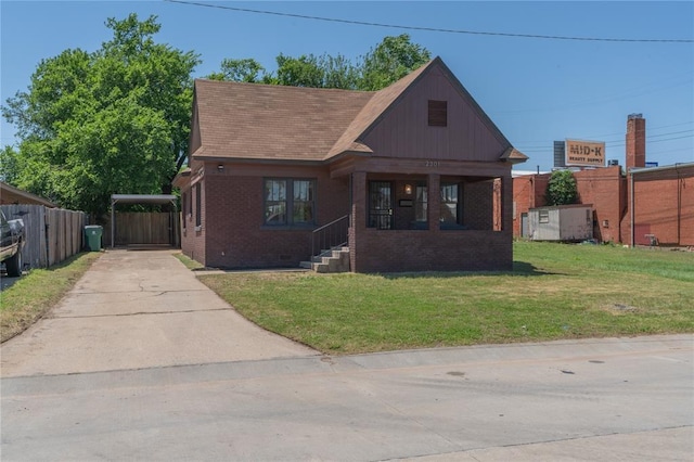 2301 N Kelham Ave, Oklahoma City, OK 73111 - view of front of property with concrete driveway, brick siding, a carport, and covered porch