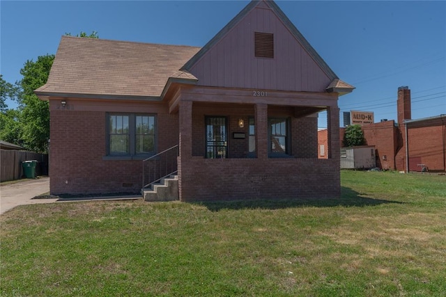 2301 N Kelham Ave, Oklahoma City, OK 73111 - view of front of home featuring brick siding, covered porch, and board and batten siding