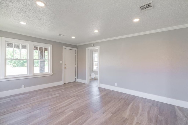 2301 N Kelham Ave, Oklahoma City, OK 73111 - foyer entrance with a textured ceiling, light wood-style floors, baseboards, recessed lighting, and crown molding