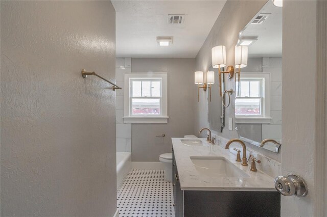 2301 N Kelham Ave, Oklahoma City, OK 73111 - full bath with tile patterned floors, toilet, double vanity, shower / tub combination, and baseboards