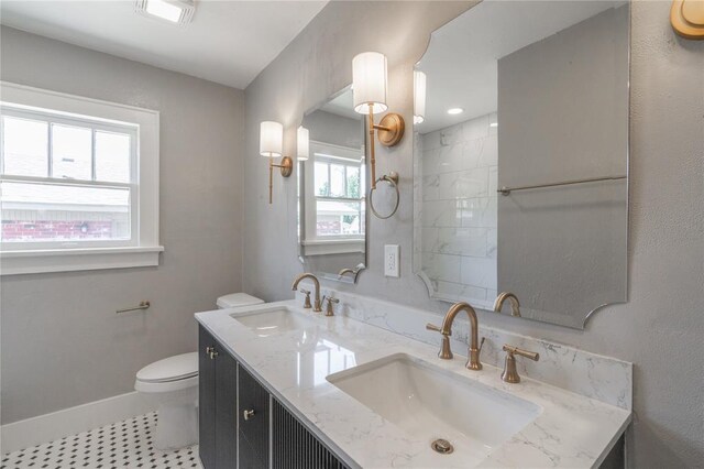 2301 N Kelham Ave, Oklahoma City, OK 73111 - full bathroom with toilet, double vanity, tile patterned flooring, and baseboards