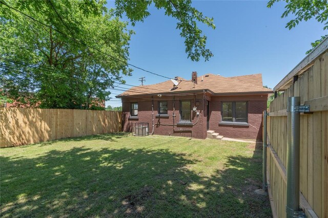 2301 N Kelham Ave, Oklahoma City, OK 73111 - rear view of property with brick siding and central air condition unit