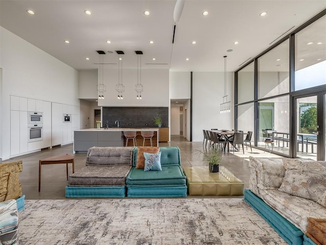 11300 N Westminster Rd, Jones, OK 73049 - living area featuring a high ceiling, recessed lighting, and a wall of windows