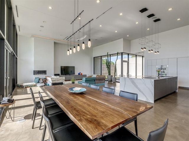 11300 N Westminster Rd, Jones, OK 73049 - dining room featuring a towering ceiling, recessed lighting, and concrete floors