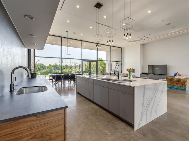 11300 N Westminster Rd, Jones, OK 73049 - kitchen with modern cabinets, a sink, finished concrete flooring, expansive windows, and a large island
